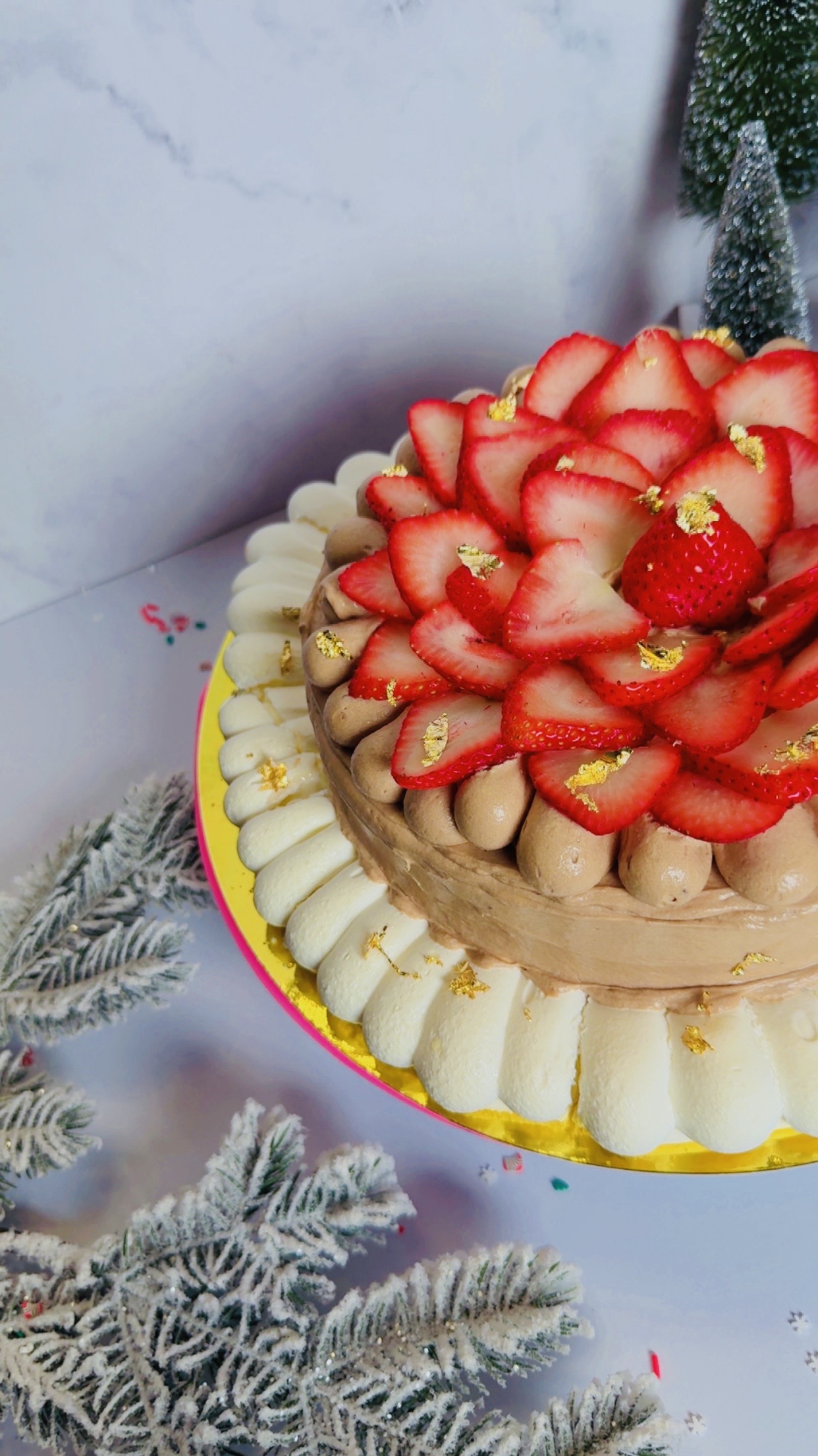 Celebration cake topped with fresh strawberries
