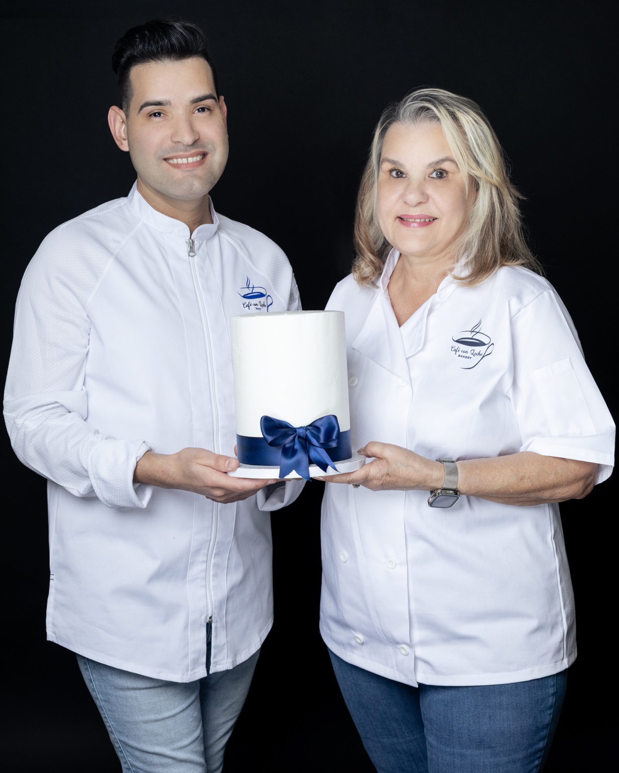 Chef Yadiel and his mother presenting a custom cake